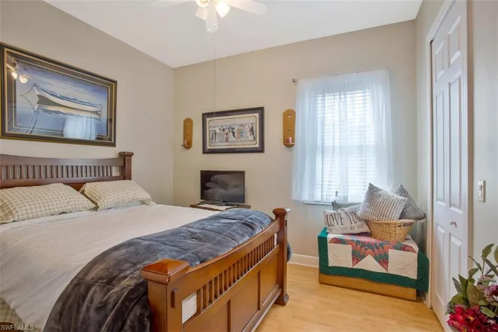 Bedroom with a closet, light wood-type flooring, and ceiling fan