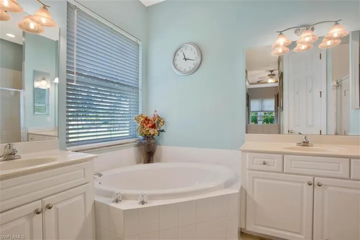 Bathroom with vanity, independent shower and bath, and ceiling fan