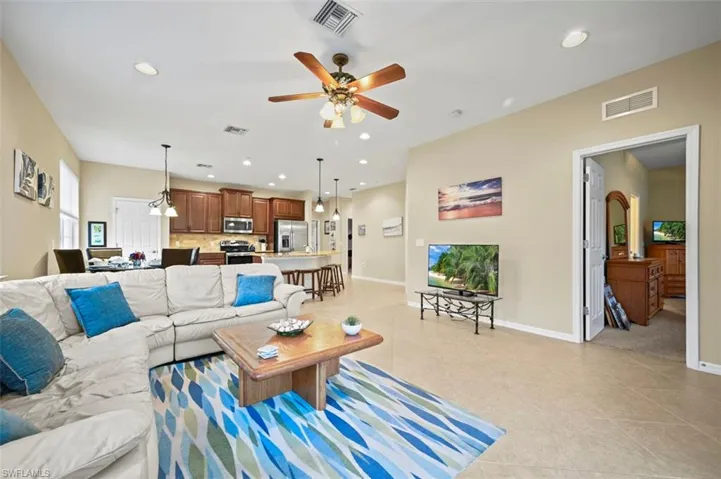 Living room with a view into the primary bedroom entry