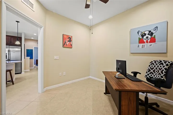 Den or office space with tile flooring