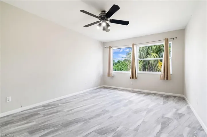 Unfurnished room featuring baseboards and a ceiling fan