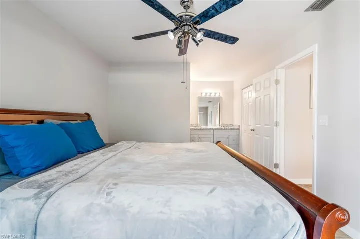 Bedroom with a ceiling fan and ensuite bathroom