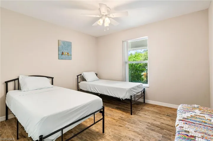 Bedroom featuring wood finished floors and a ceiling fan