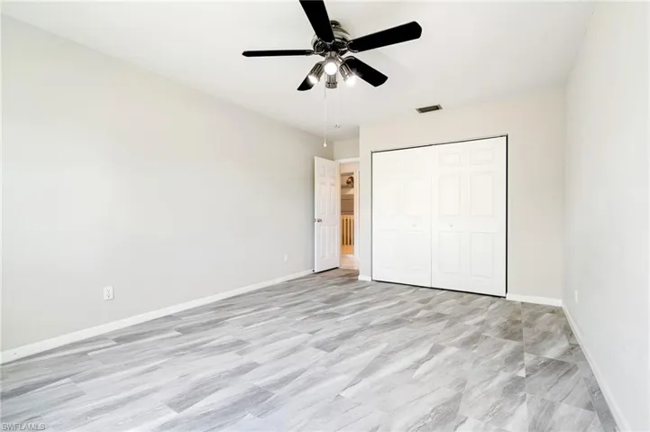 Unfurnished bedroom featuring a ceiling fan and a closet