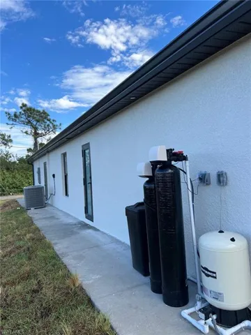 View of property exterior featuring central AC unit and stucco siding