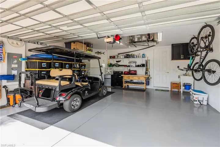 Garage with a garage door opener, epoxy floor and storage shelves