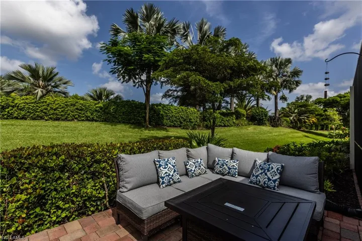 Outdoor living space surrounded by beautiful upgraded tropical landscaping