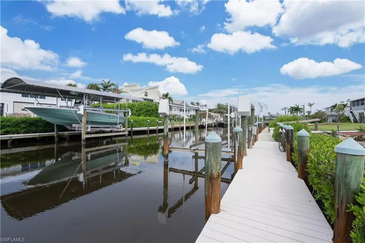 Dock featuring boat lift and a water view