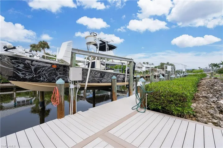 Dock with boat lift and a water view