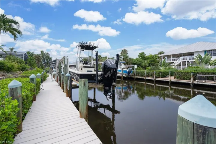 Dock featuring boat lift and a water view