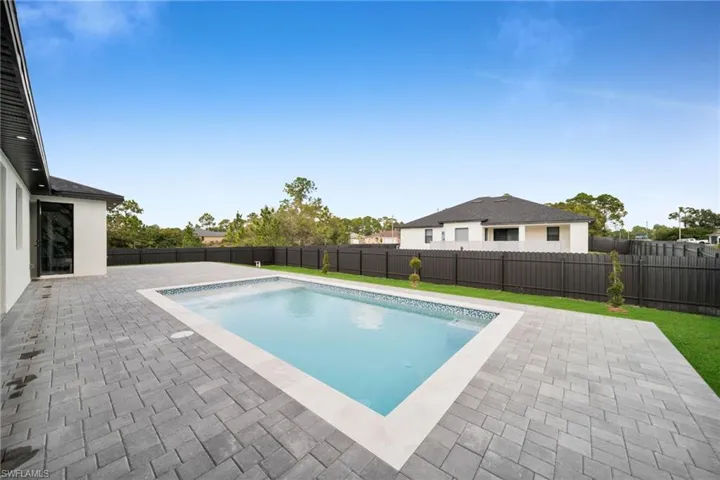 View of pool with a patio and a fenced backyard