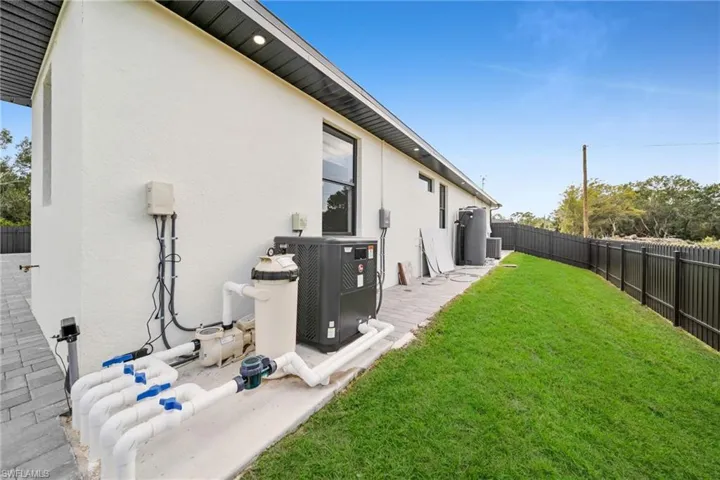 Rear view of house featuring a fenced backyard, stucco siding, and a patio