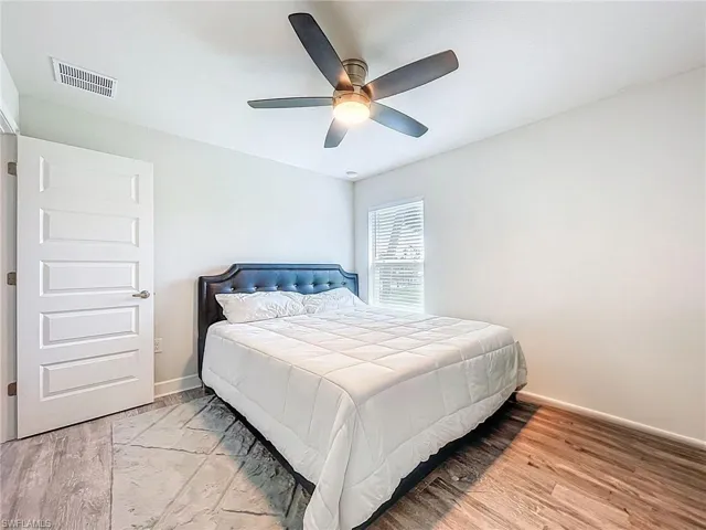 Bedroom with wood finished floors and ceiling fan