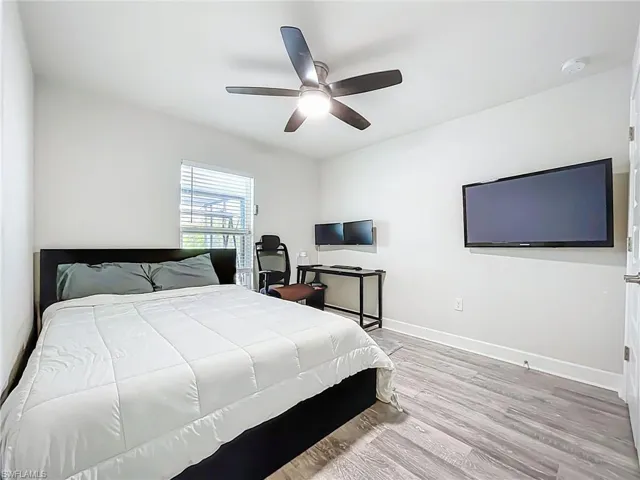 Bedroom featuring wood finished floors and ceiling fan