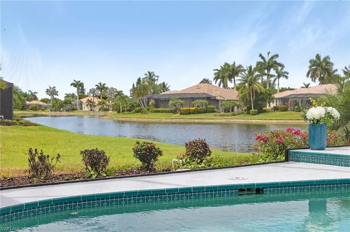 View of pool featuring a water view and a yard