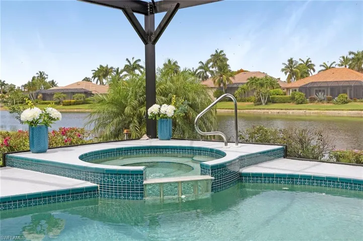 View of swimming pool featuring an in ground hot tub