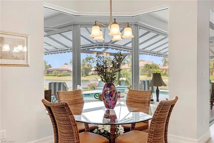 Dining room with a notable chandelier and a water view