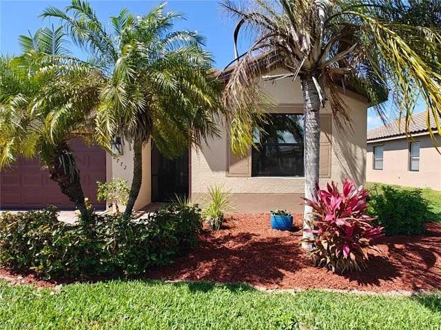 View of home's exterior with stucco siding and an attached garage