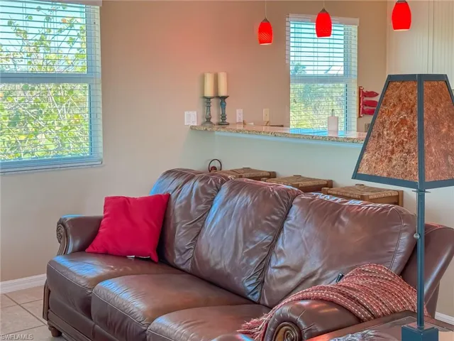 Living room with baseboards and tile patterned floors