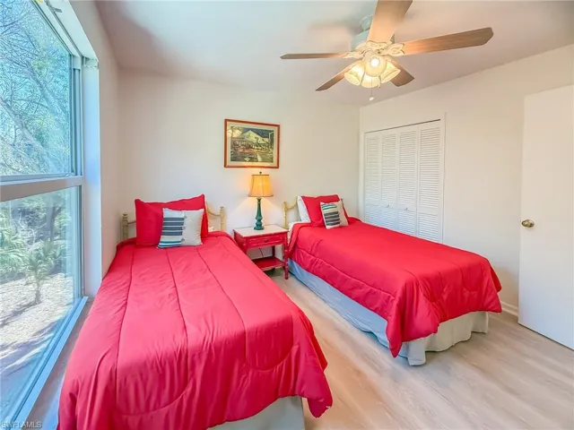 Bedroom featuring a closet, a ceiling fan, and wood finished floors