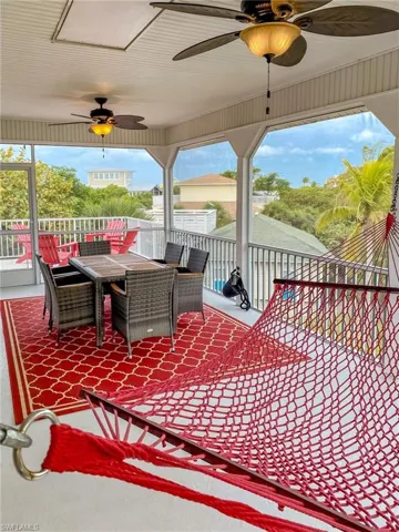 Wooden deck featuring ceiling fan and outdoor dining space