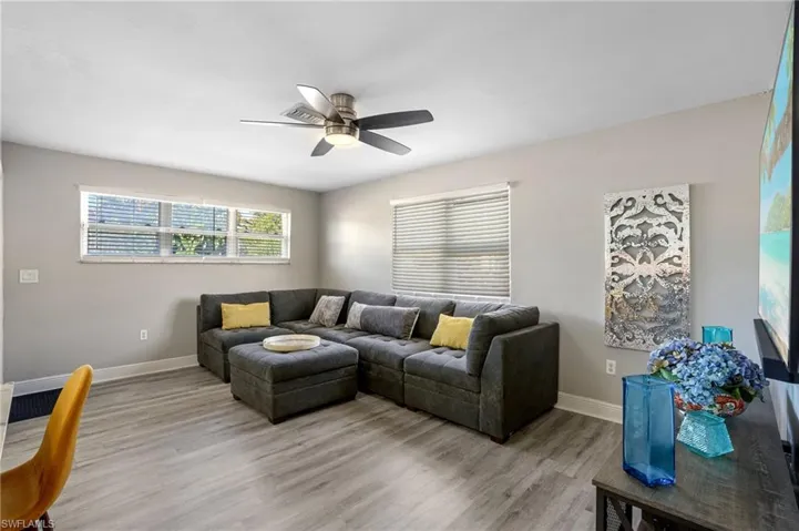 Living room with a ceiling fan and light wood finished floors
