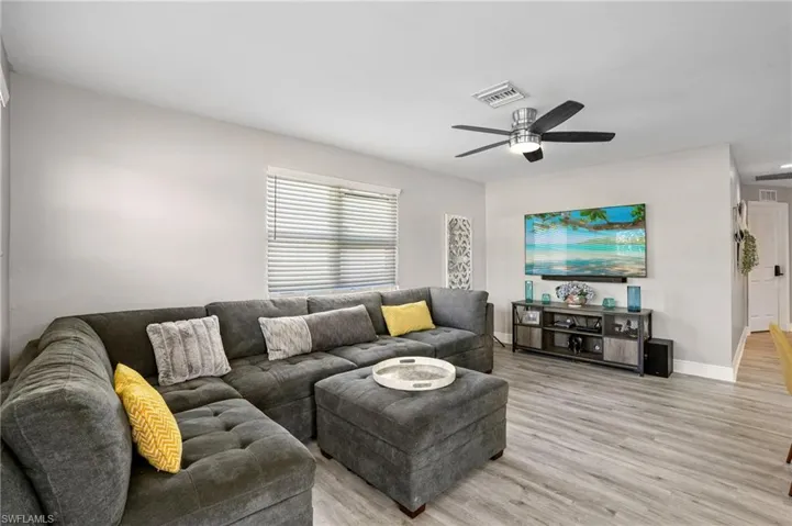 Living area featuring light wood-style floors and a ceiling fan