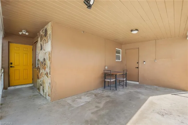 View of exterior entry with a patio area and stucco siding