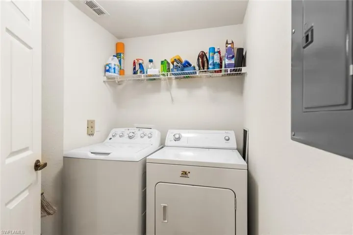 Laundry area with washer and dryer and electric panel