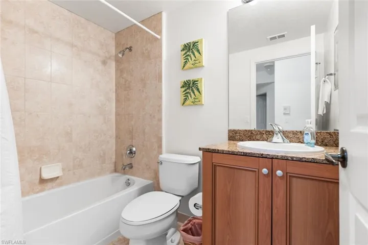 Full bathroom featuring vanity, toilet, and shower / tub combo