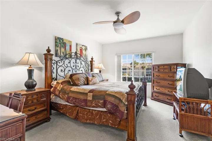 Carpeted bedroom with ceiling fan