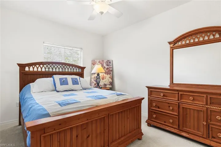 Carpeted bedroom with ceiling fan