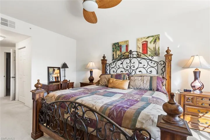 Bedroom featuring light carpet and ceiling fan