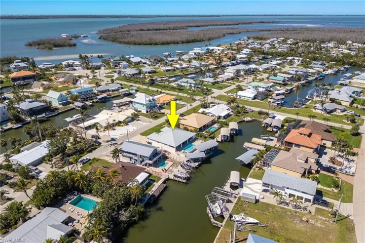 Aerial overview of property's location with a nearby body of water and nearby suburban area