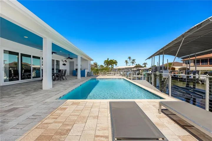 View of swimming pool with a patio and outdoor dining space