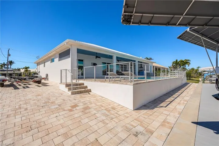 View of patio / terrace with a ceiling fan and a swimming pool
