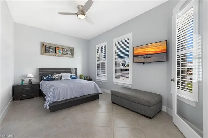 Bedroom with a ceiling fan and light tile patterned floors