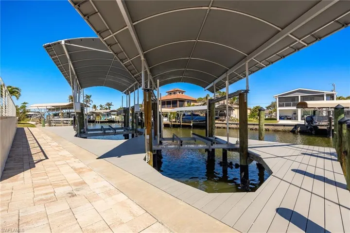 Dock area with boat lift and a water view