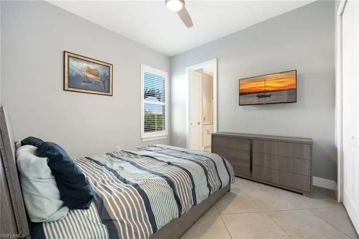 Bedroom with tile patterned flooring and ceiling fan