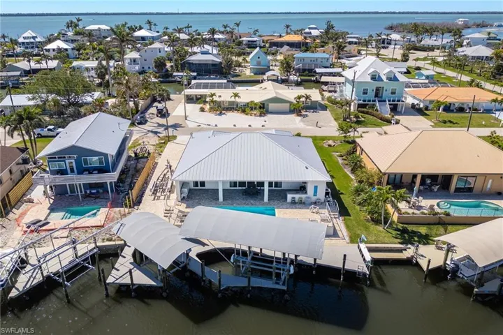 Aerial view of residential area featuring a large body of water