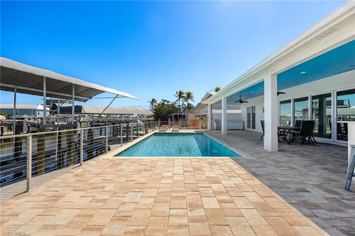 View of pool featuring a patio area and outdoor dining area