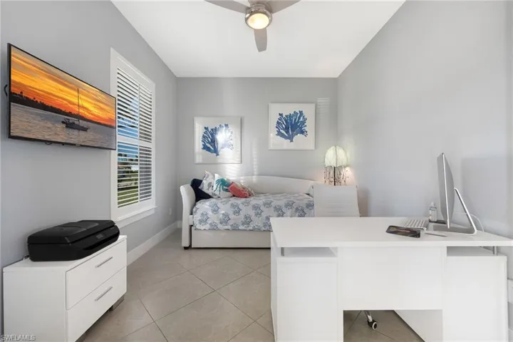 Bedroom featuring light tile patterned floors and ceiling fan