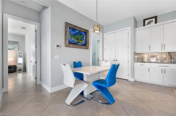 Dining space featuring light tile patterned floors and baseboards