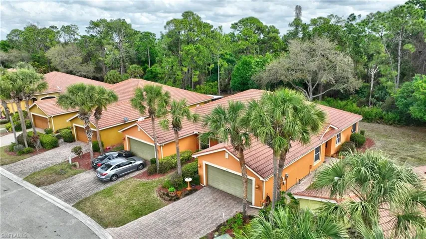 Front door is on the side of villa; private preserve view off the back lanai