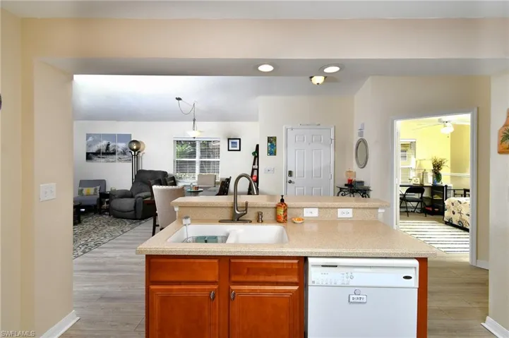 Kitchen bar looking out to towards dining/living space, front door and den to the right
