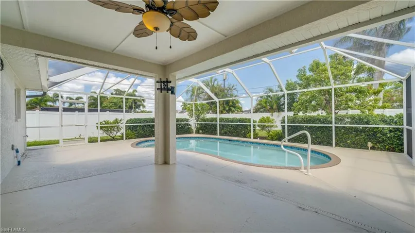 Covered lanai with decorative ceiling and fan. Pool resurfaced in 2026