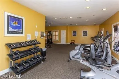 Gym featuring carpet floors and recessed lighting