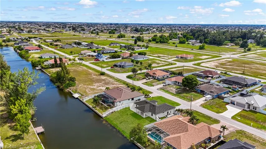 Canal-front property featuring a private dock and direct water access