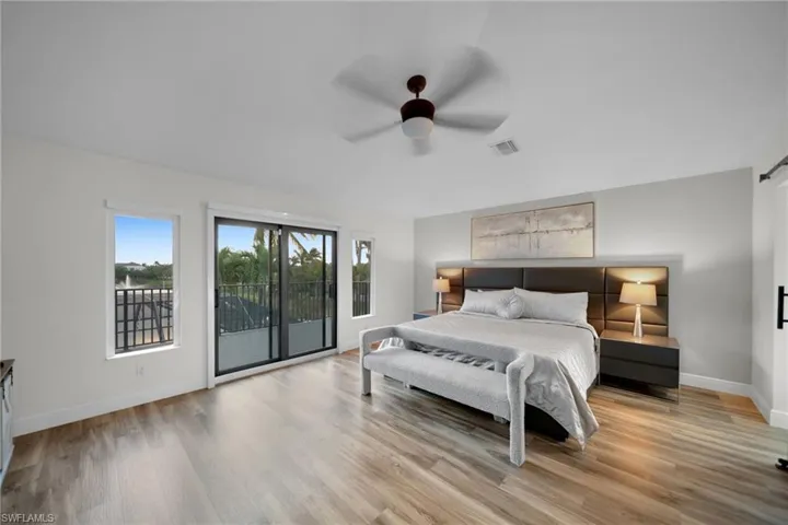 Bedroom with visible vents, a ceiling fan, light wood-type flooring, baseboards, and access to outside