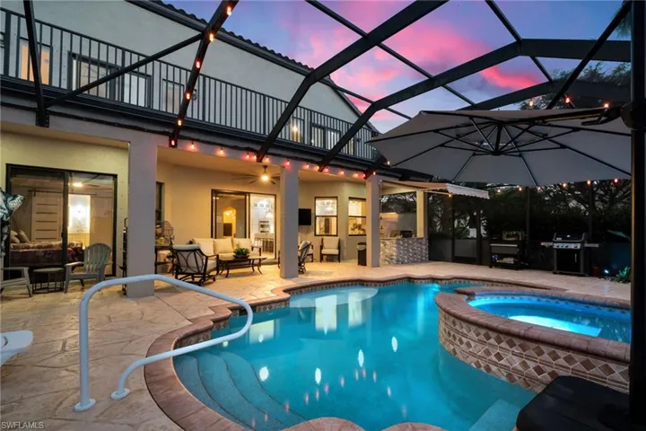 View of swimming pool featuring grilling area, an outdoor hangout area, a patio area, and a pool with connected hot tub